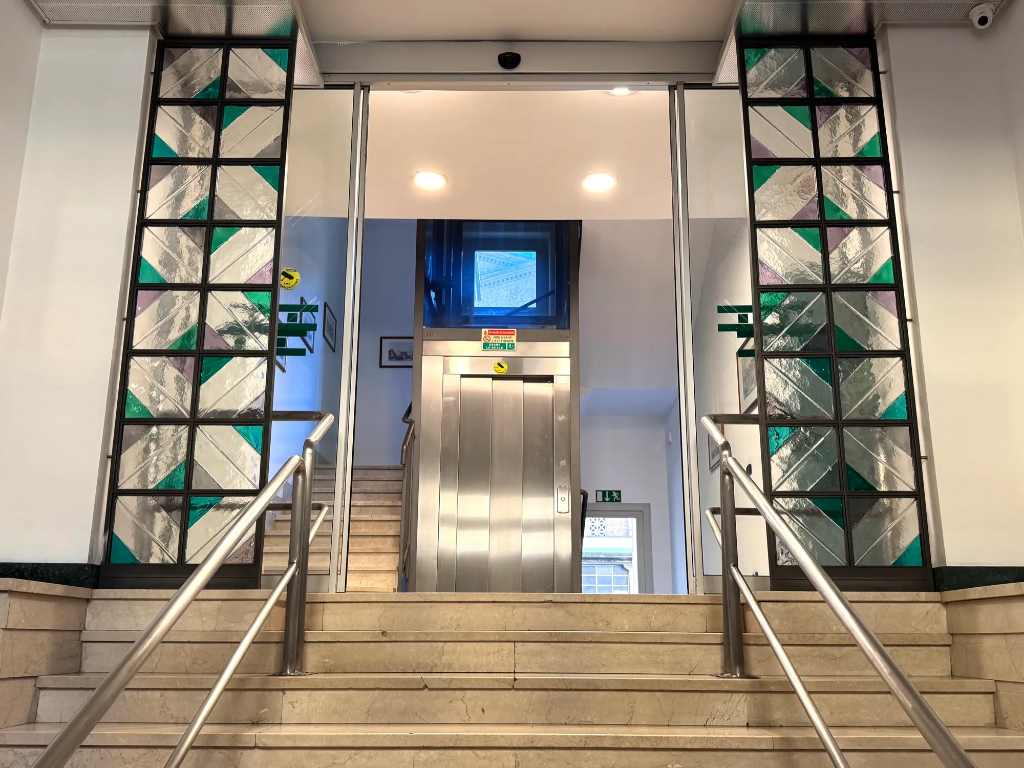 Pensionato Universitario Bertoni entrance with stairs, elevator and stained glass