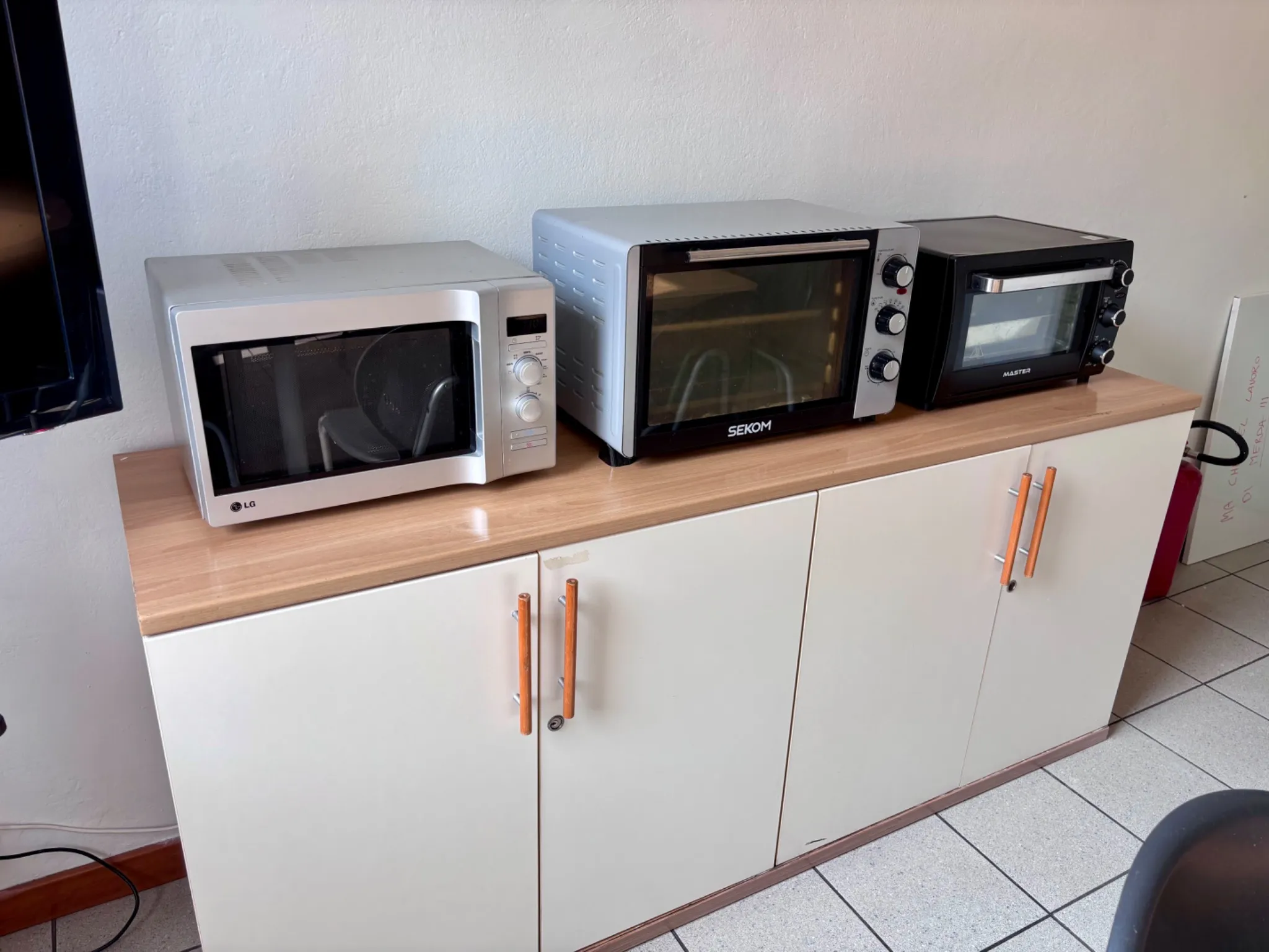 Microwaves and ovens in the student kitchen at Pensionato Bertoni