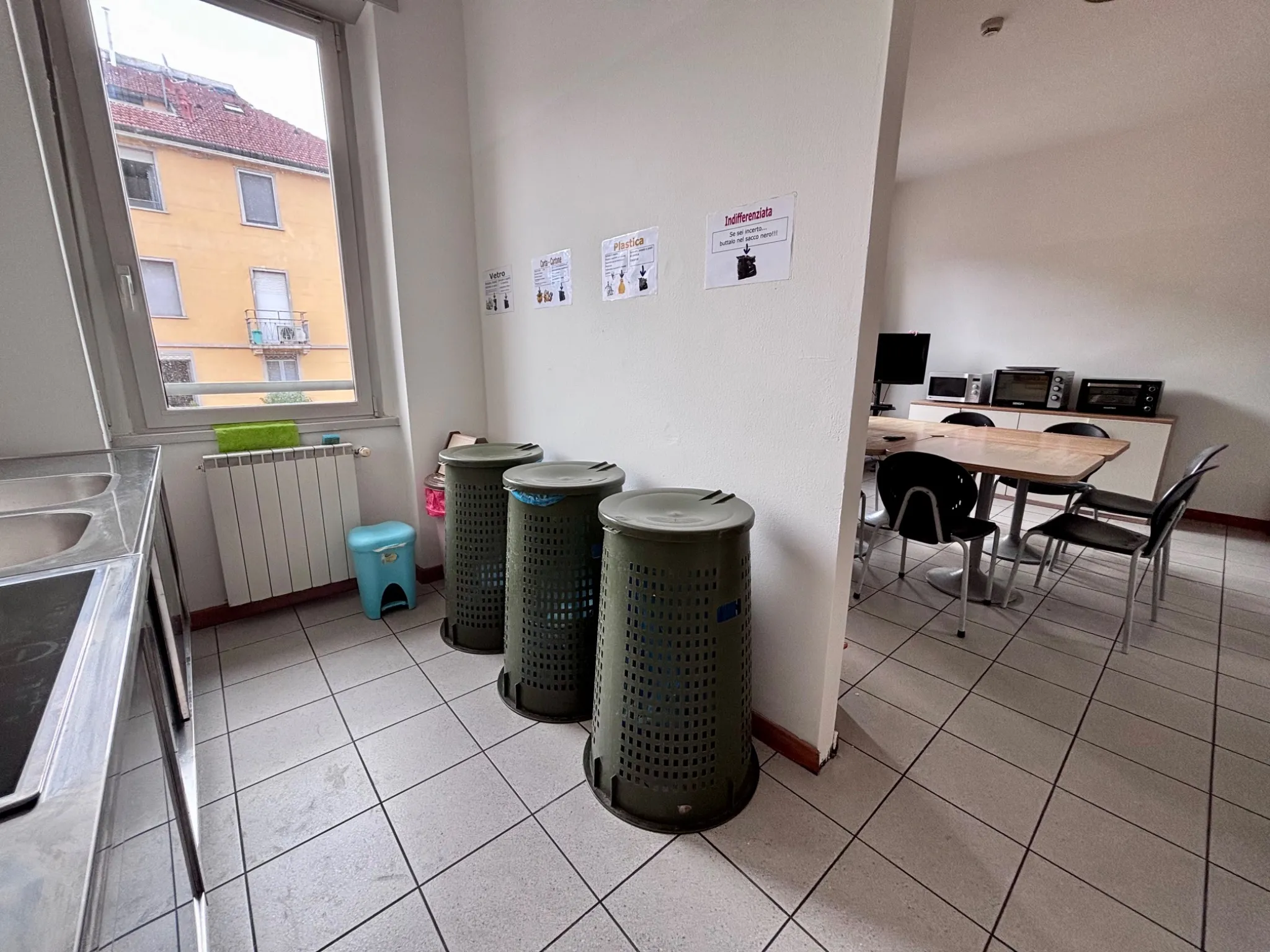 University residence kitchen with recycling bins and dining area